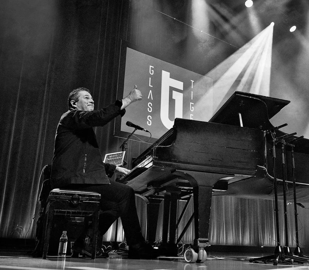 at the piano on stage